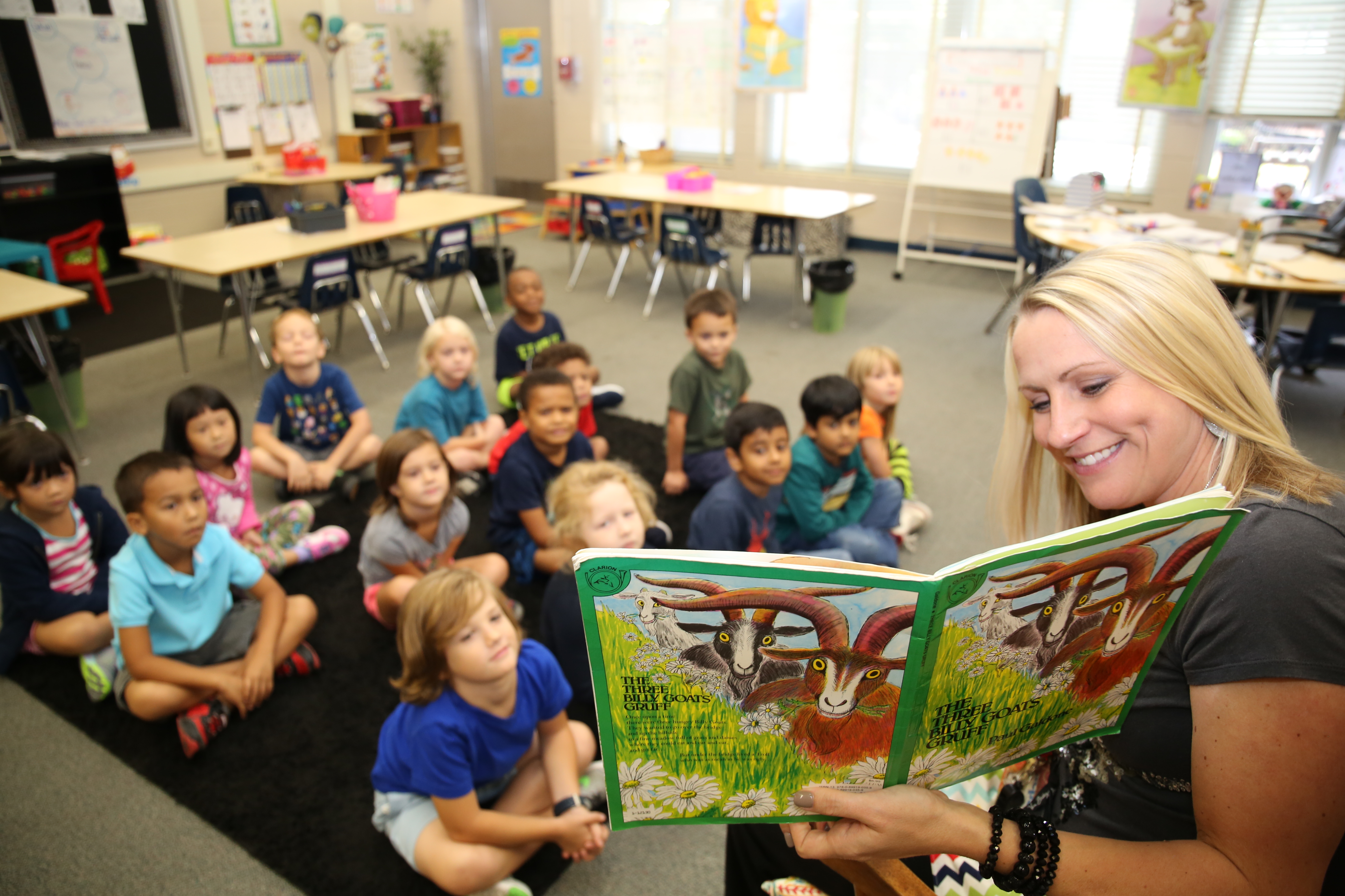 Teacher reading a book to students.