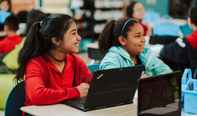 Photo shows students in front of laptops.