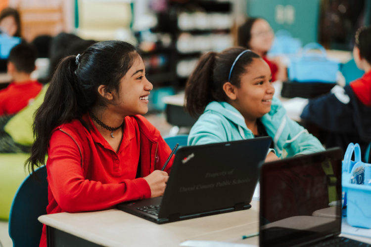 Photo shows students in front of laptops.