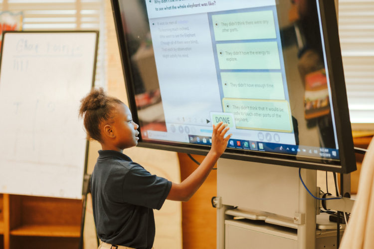 Photo of a student at a whiteboard