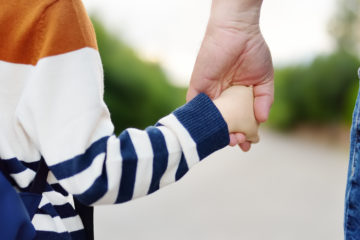 Stock photo of parent and child hand in hand