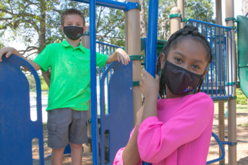 Photo of two children social distancing on a school playground