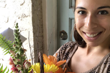 Photo of West Riverside Elementary teacher Gabriella Solano holding a flower bouqet