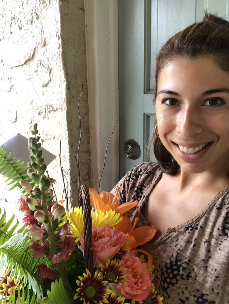 Photo of West Riverside Elementary teacher Gabriella Solano holding a flower bouqet