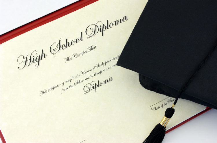High school diploma and black cap with tassle
