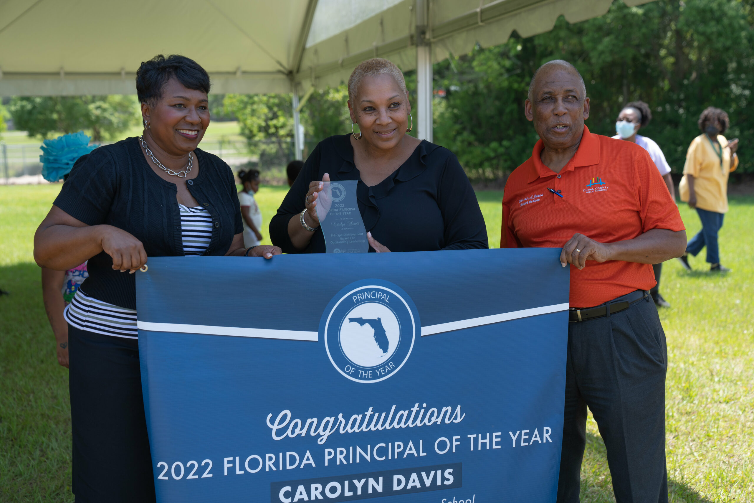 Carolyn Davis poses next to Superintendent Dr. Diana Greene and Board Chair Warren Jones