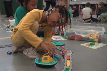 Students engaged in learning in the Lego Lab