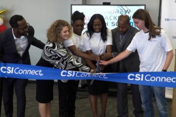 Andrew Jackson students and staff, along with CSI staff, cut the ribbon on the school's new tech lab