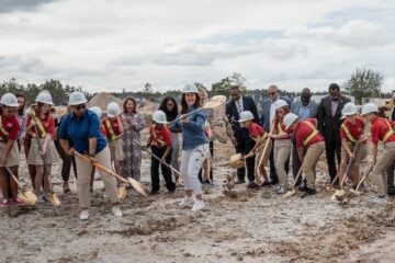 Image of students and district leaders breaking ground during the ceremony