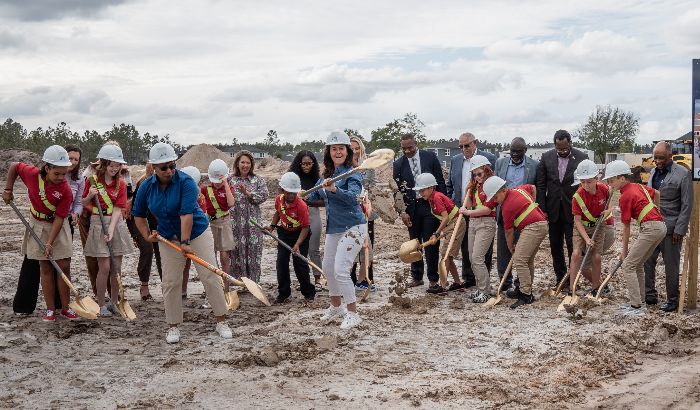 Image of students and district leaders breaking ground during the ceremony