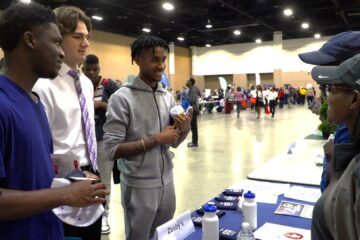 Students interact with potential employers at annual employment fair.