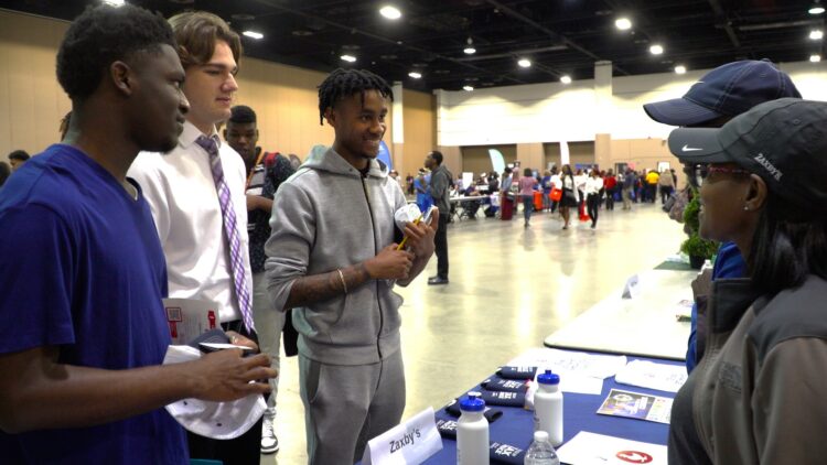 Students interact with potential employers at annual employment fair.