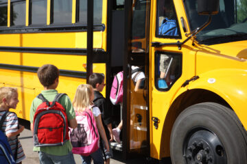Students boarding a school bus.