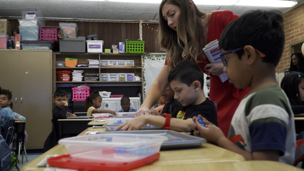 Brookview Elementary teacher helps students spell out words in class