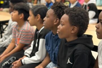 Englewood Elementary students are seated as they listen to the JA in a Day presentation