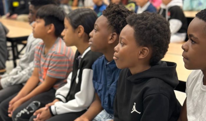 Englewood Elementary students are seated as they listen to the JA in a Day presentation