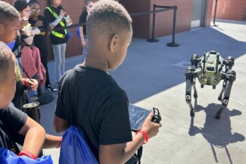 Students interact with live robot at the festival.